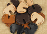 Pile of leather door key covers by Fenner Benedict Handmade